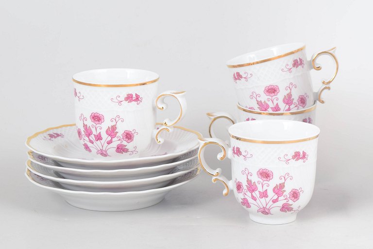 Set of four Hollóháza coffee cups with saucers, pink floral decoration.