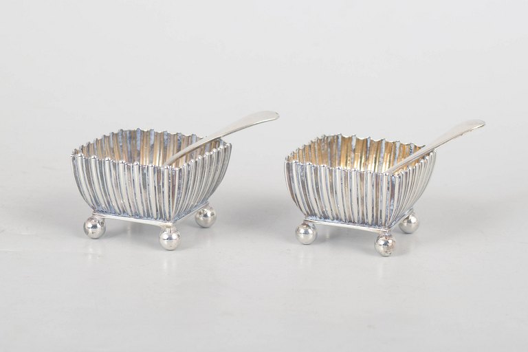 Pair of English sterling silver salt cellars with matching spoons.