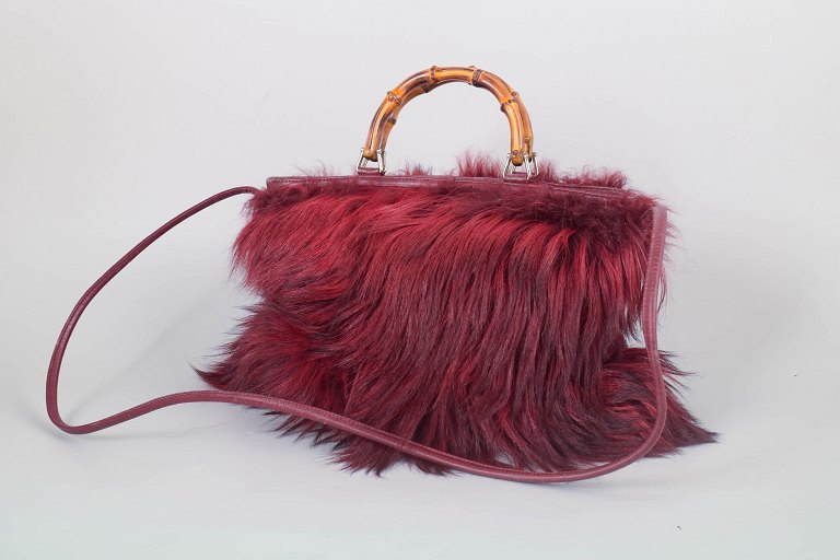 Gucci bamboo handle leather and fur handbag.